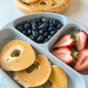 Dipped pear pancakes served with strawberries and blueberries.