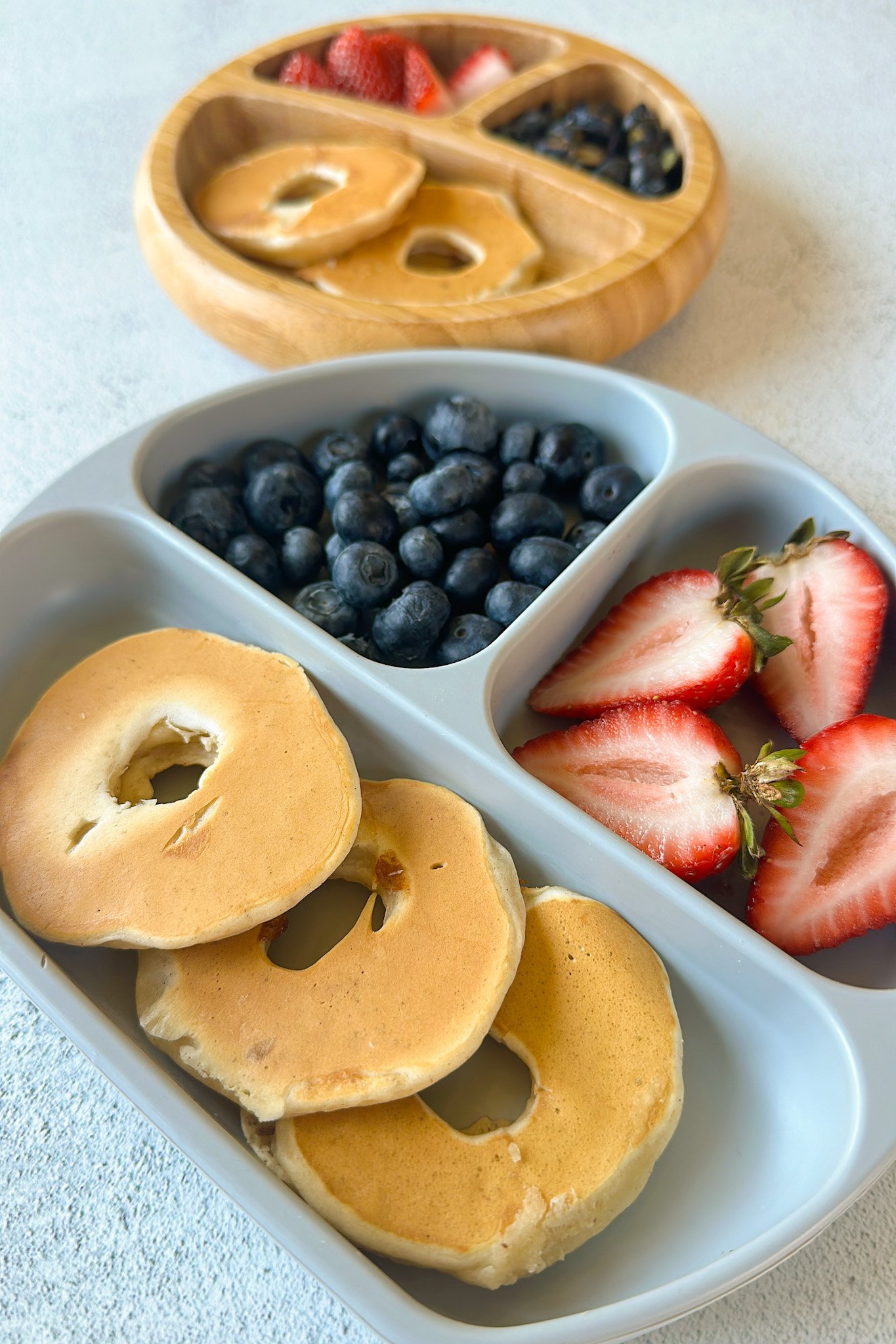 Dipped pear pancakes served with strawberries and blueberries.