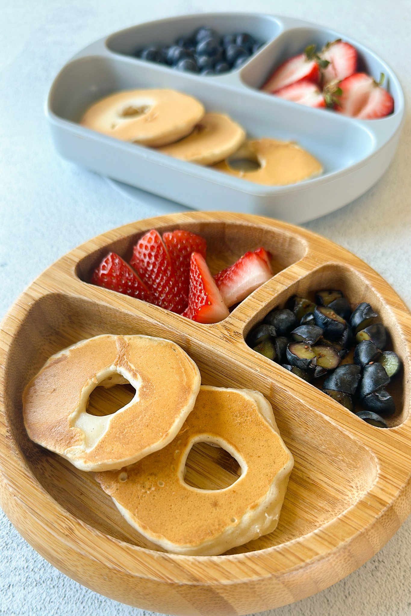 Dipped pear pancakes served with strawberries and blueberries.