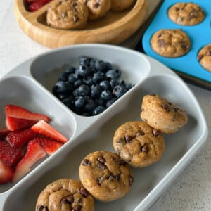 Peanut butter chocolate chip muffins served with berries.
