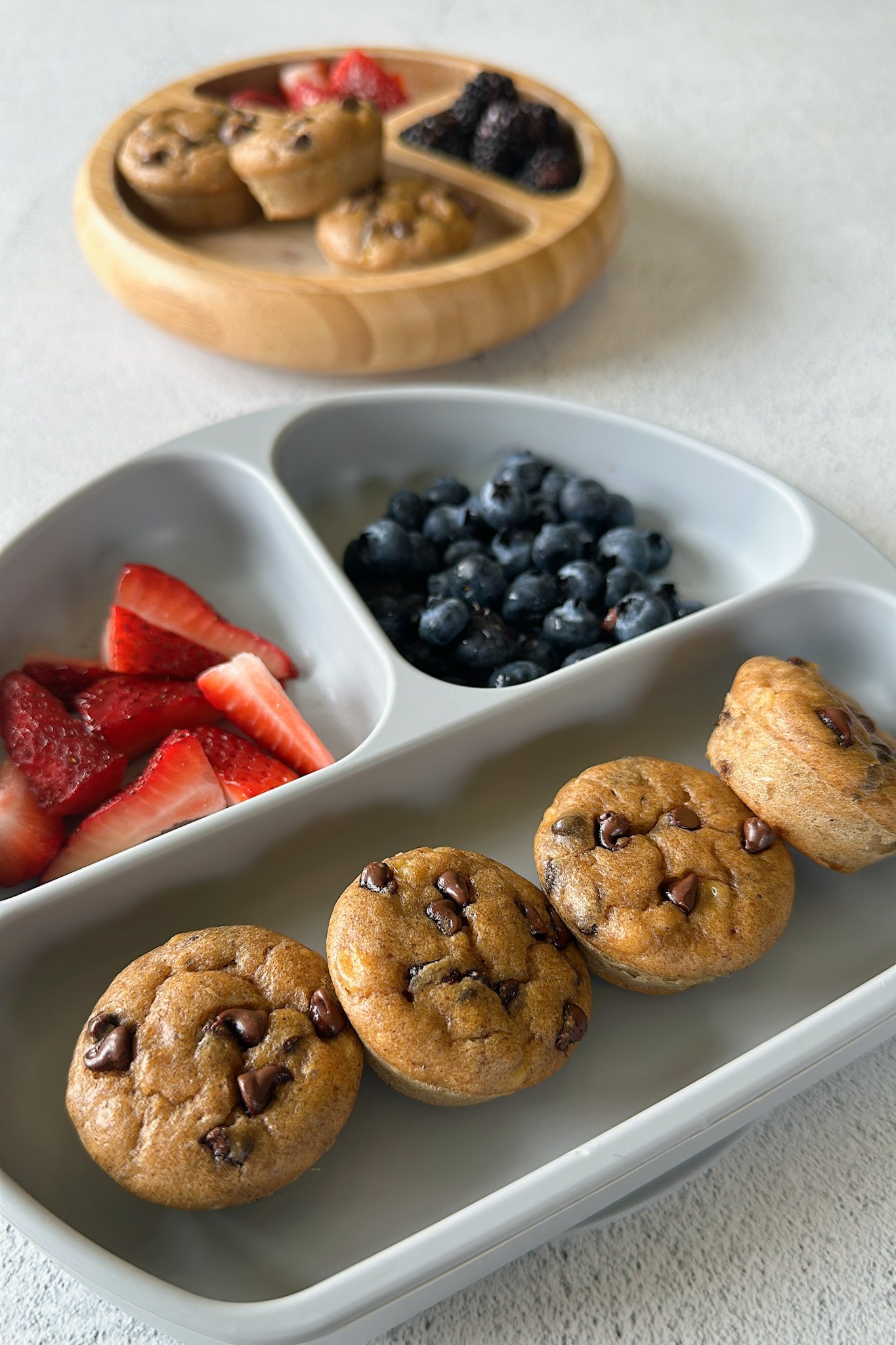 Peanut butter chocolate chip muffins served with berries.