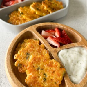 Sweet corn fritters served with strawberries and a dip.