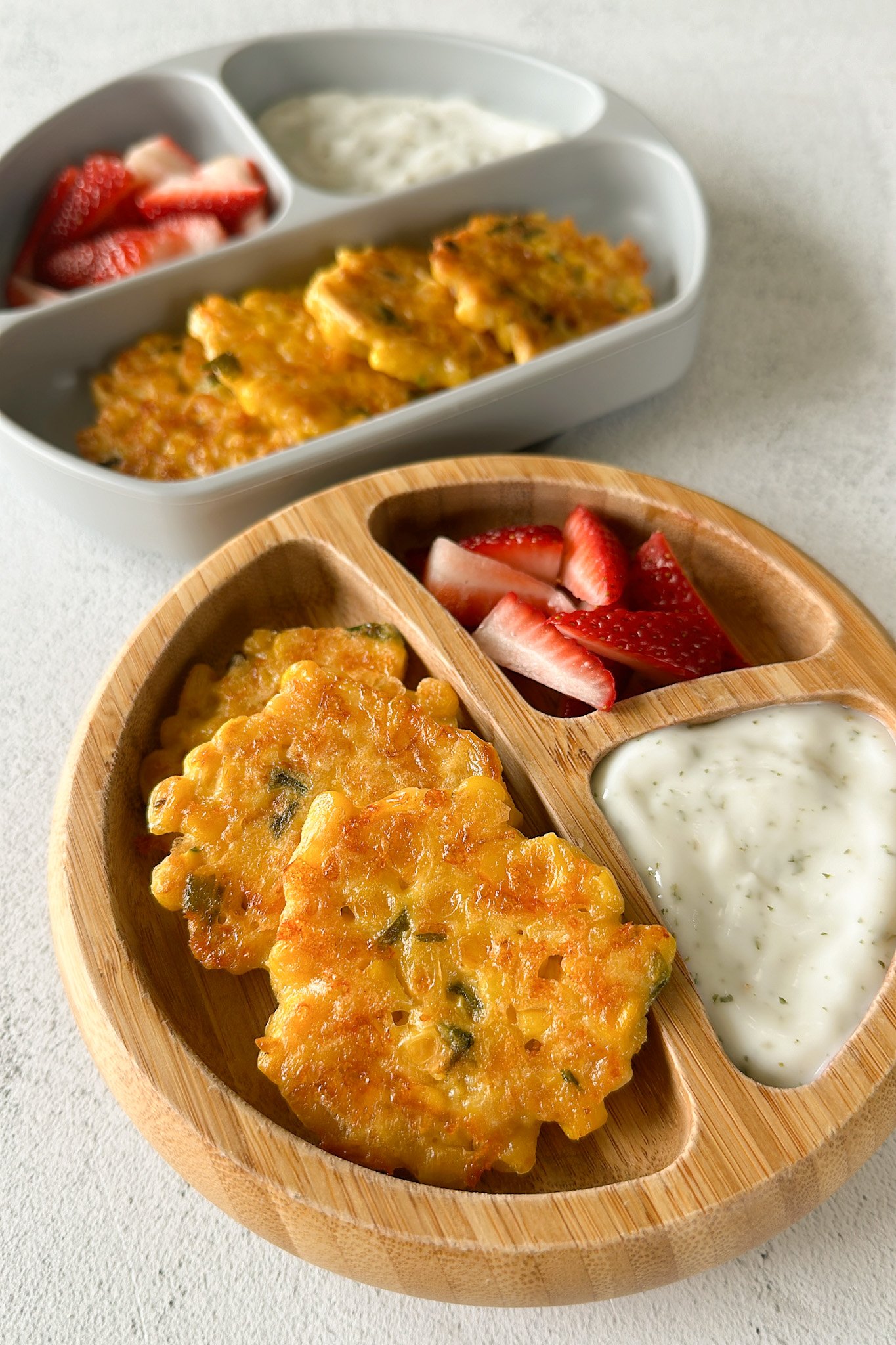Sweet corn fritters served with strawberries and a dip.