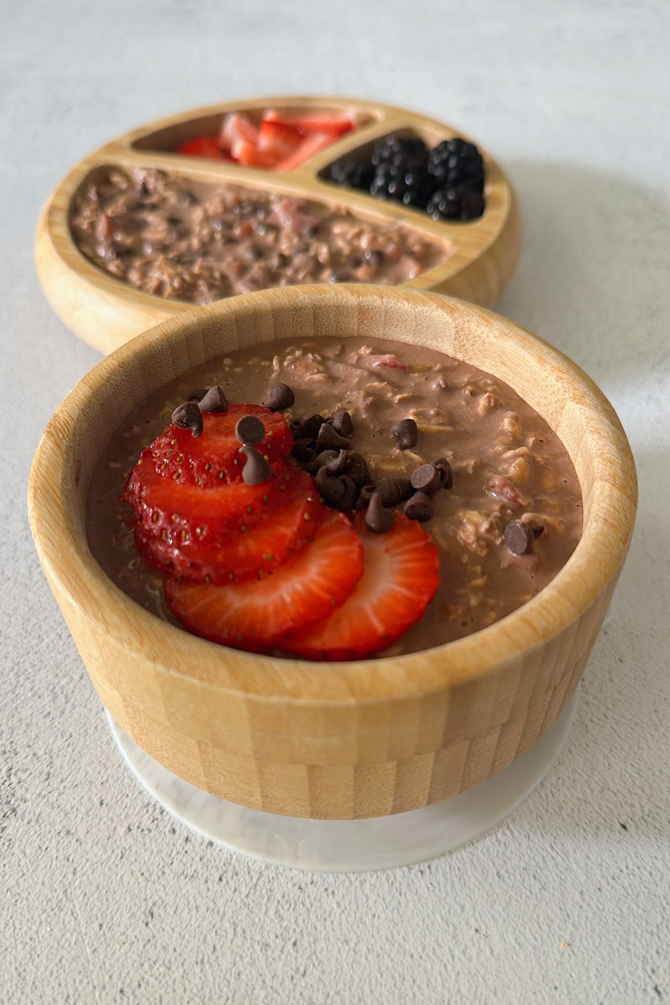 Chocolate strawberry overnight oats topped with strawberries and chocolate chips.