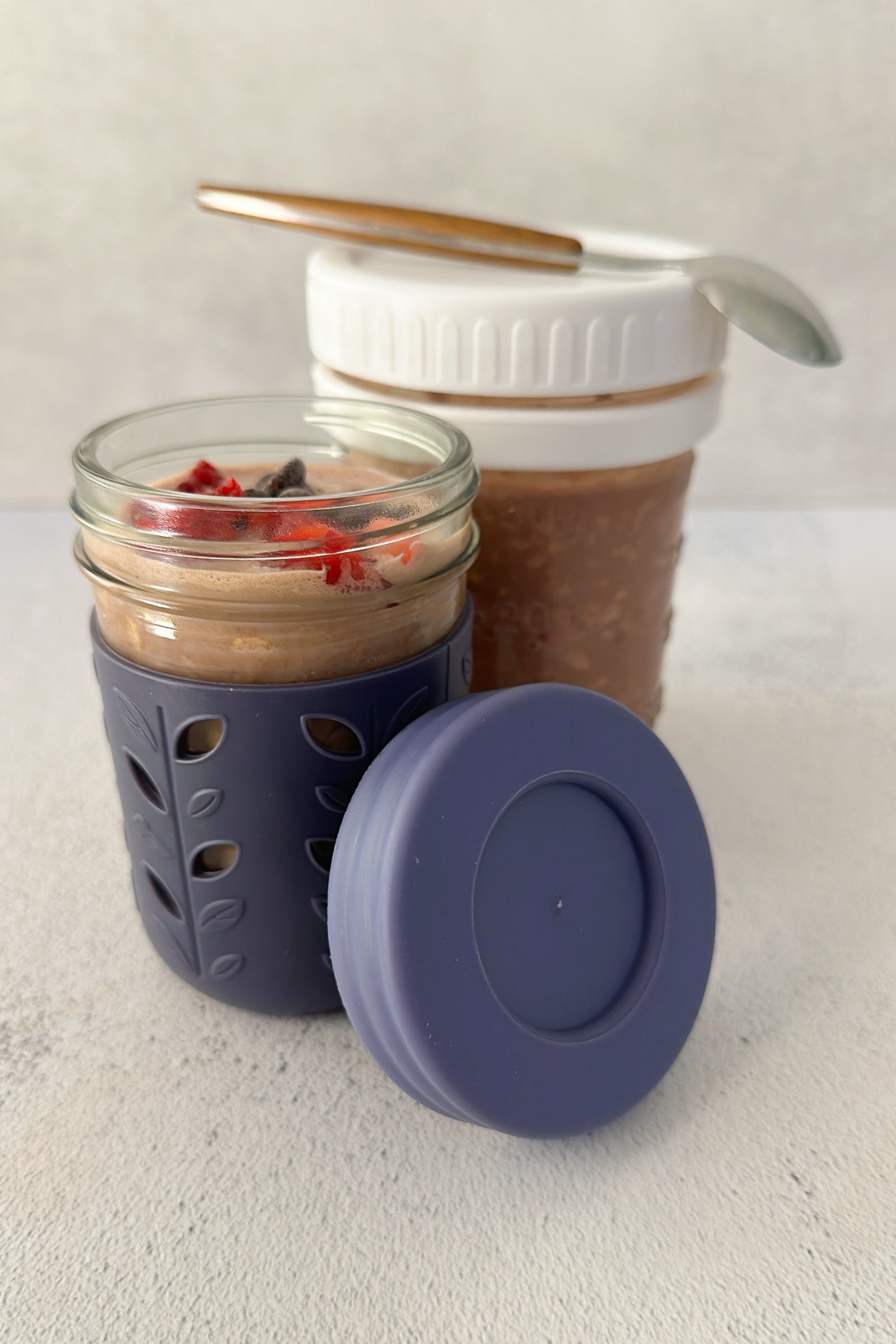 Chocolate strawberry overnight oats topped with strawberries and chocolate chips.