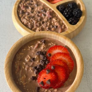 Chocolate strawberry overnight oats topped with strawberries and chocolate chips.