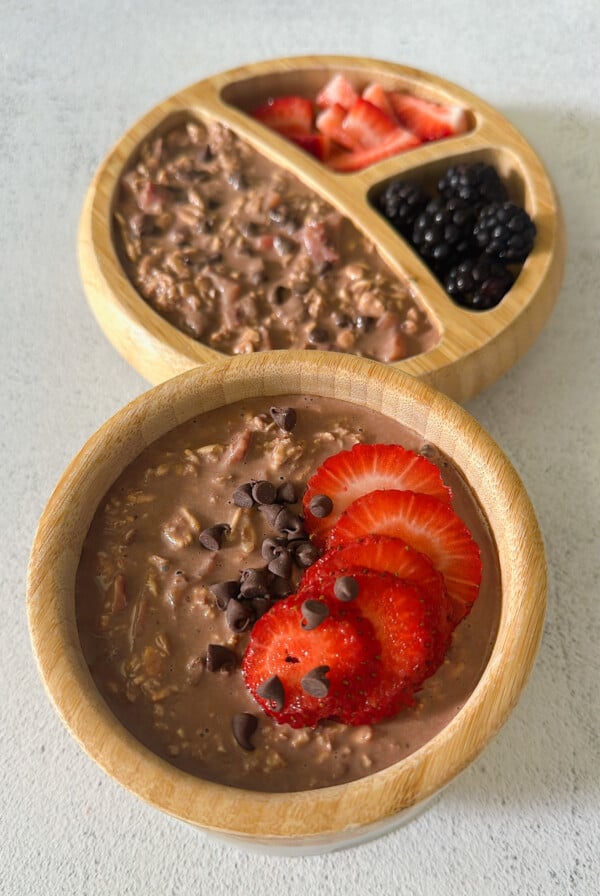 Chocolate strawberry overnight oats topped with strawberries and chocolate chips.