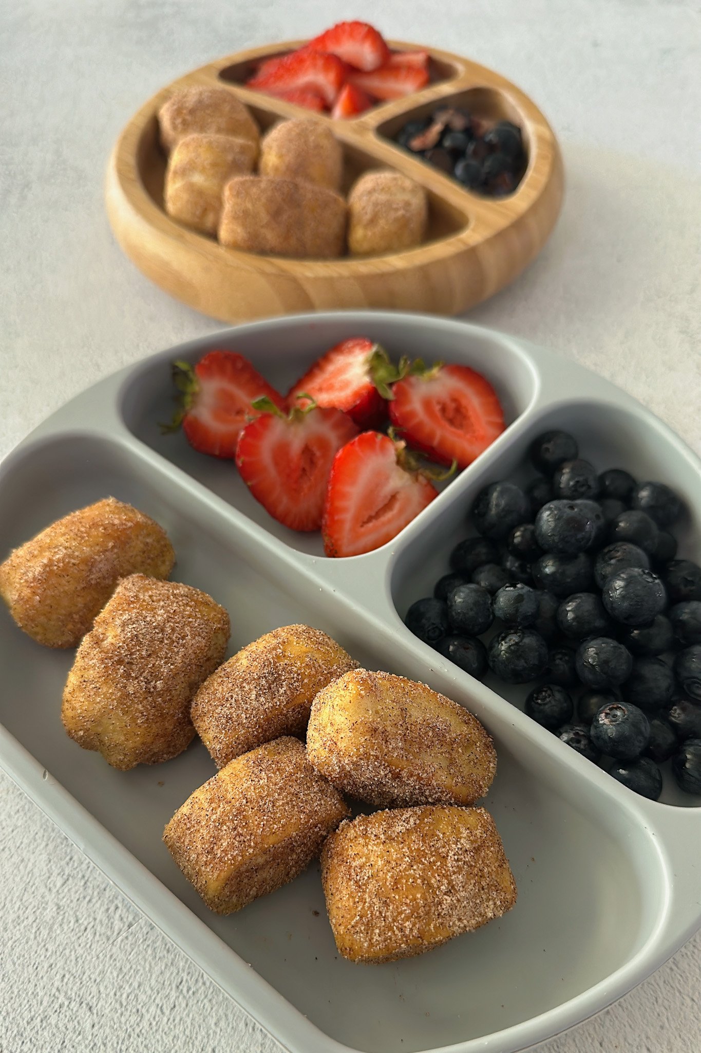 2 ingredient dough pretzel bites served with strawberries and blueberries.