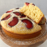 Yogurt plum cake on a cake stand.