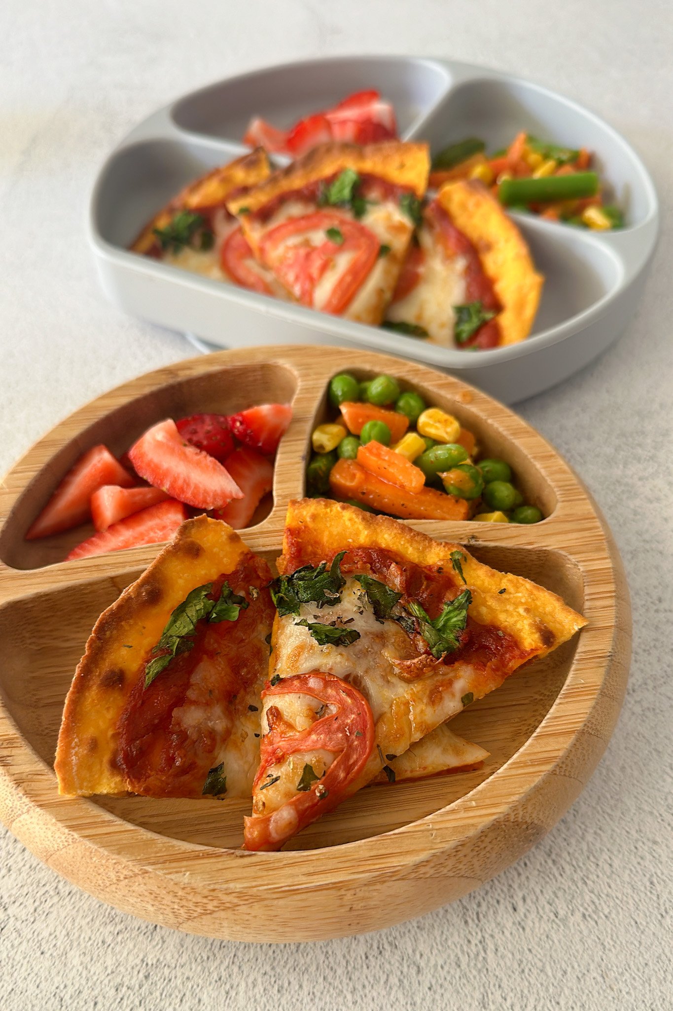 Air fryer tortilla pizza served with strawberries and sautéed veggies.