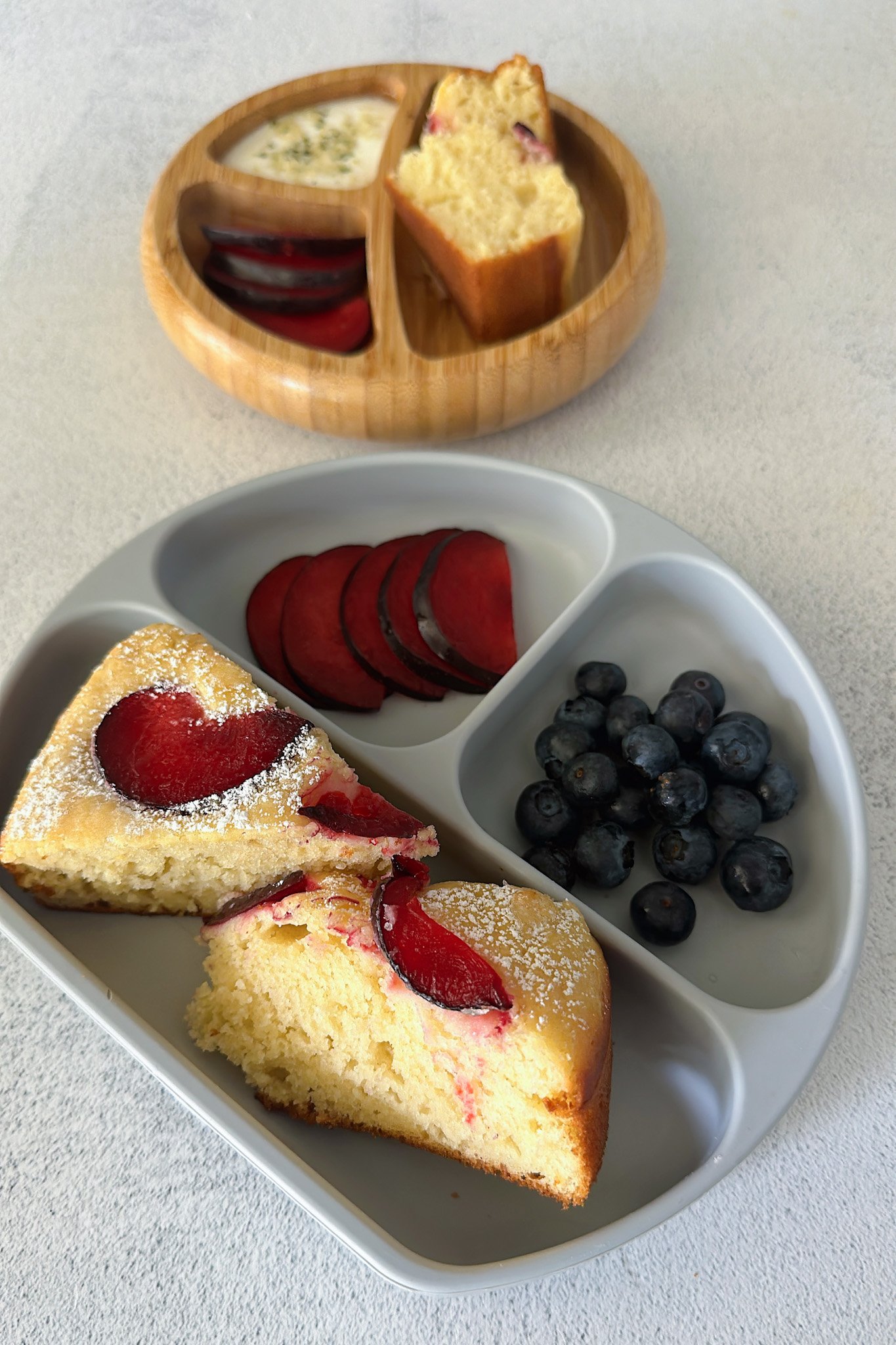 Yogurt plum cake served with fruits.