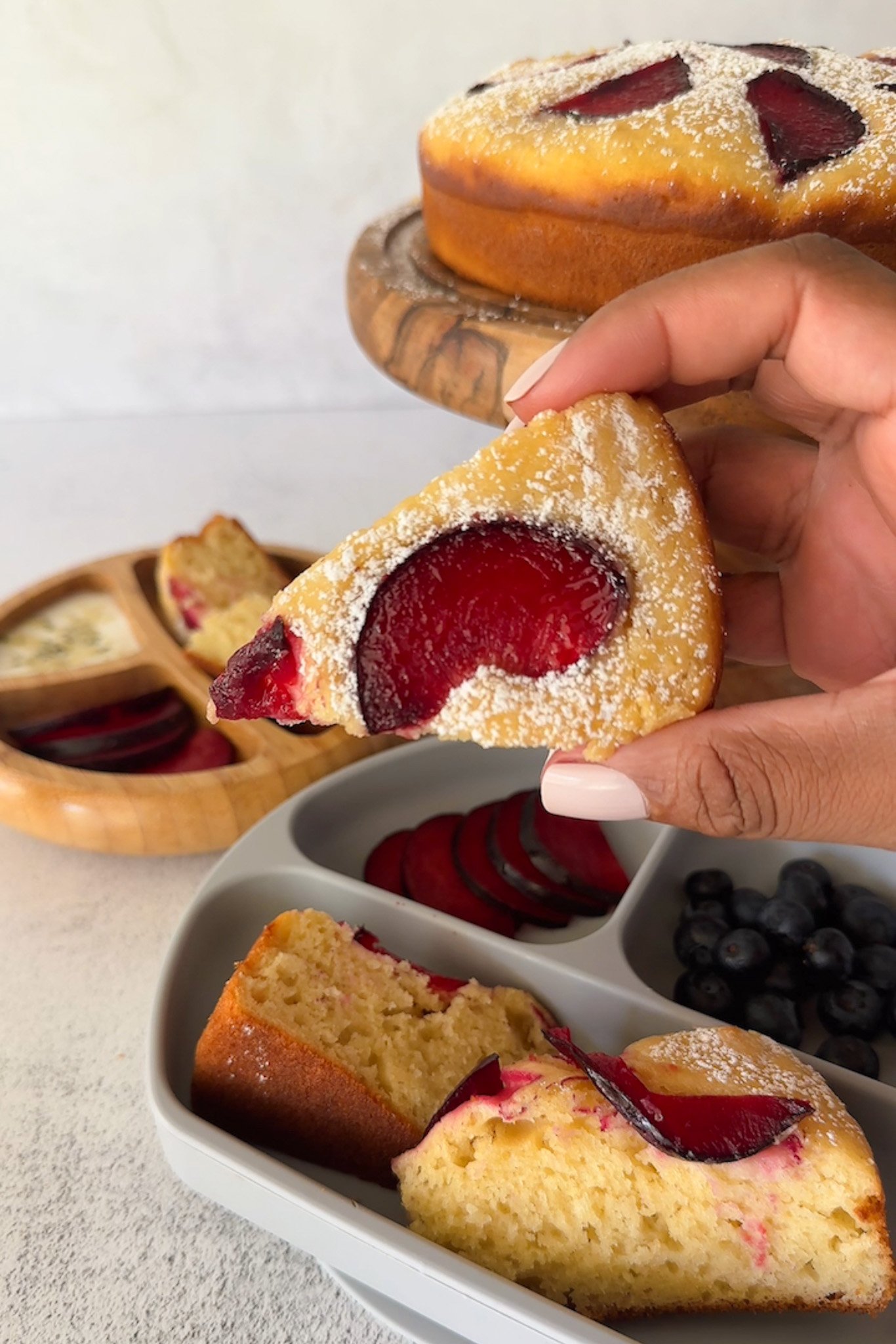 Yogurt plum cake served with fruits.