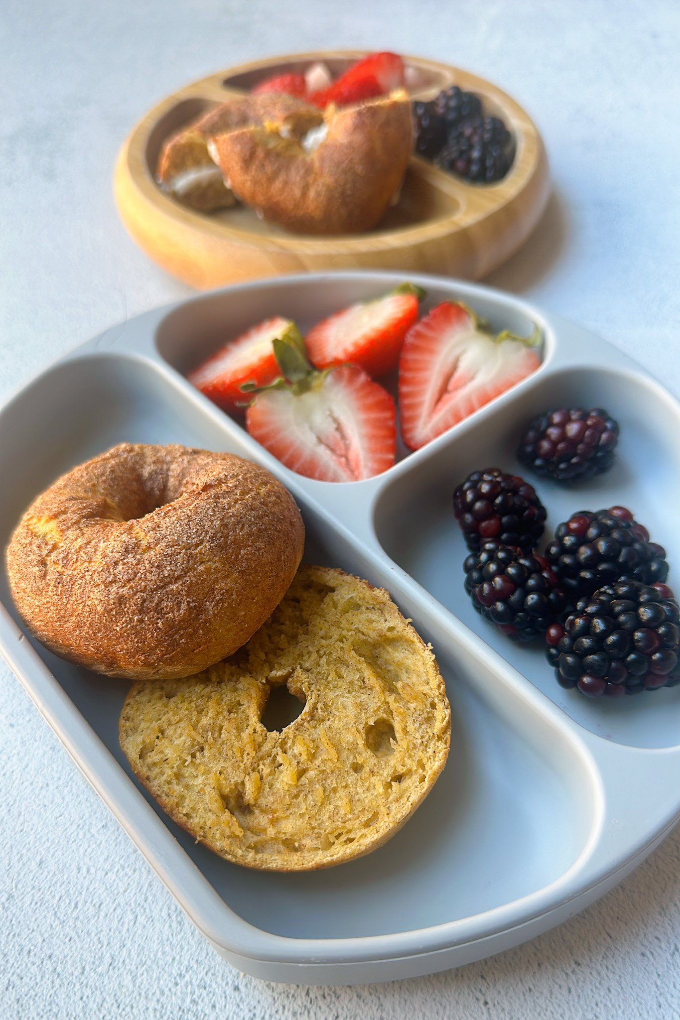 Mini pumpkin bagels served with berries.