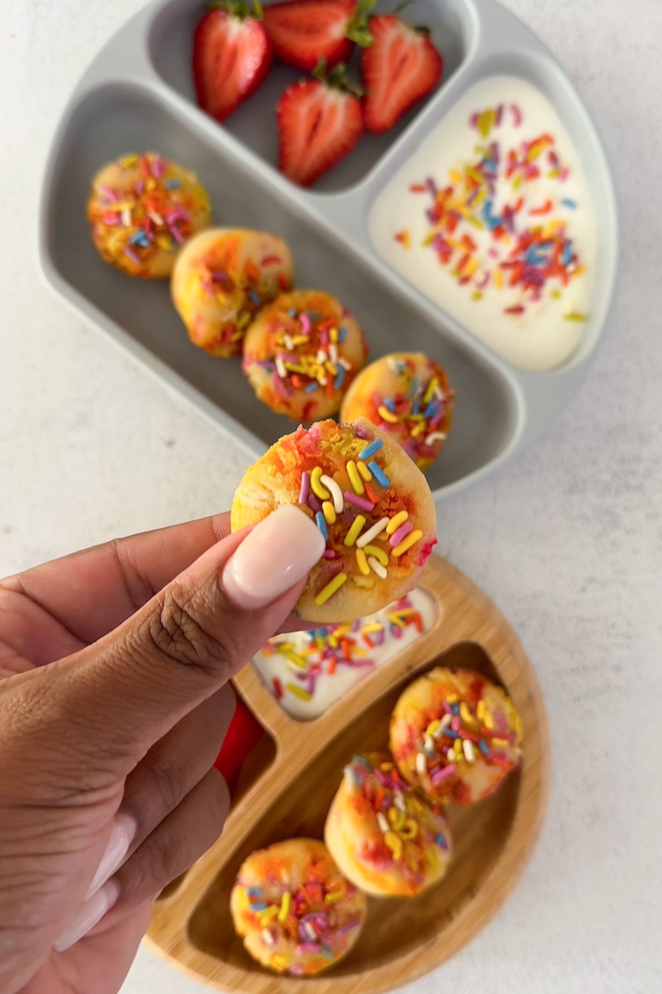 Funfetti muffins served with yogurt and strawberries.