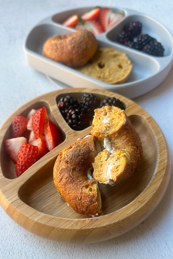 Mini pumpkin bagels served with berries.