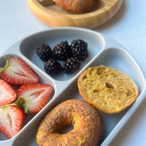 Mini pumpkin bagels served with berries.