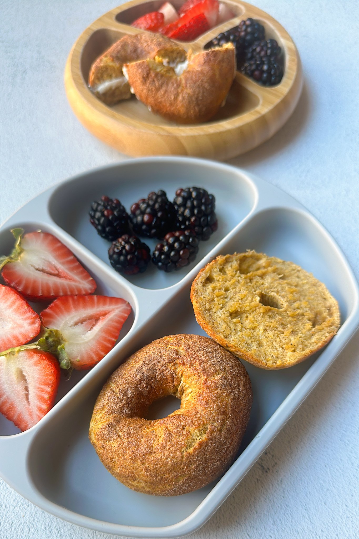 Mini pumpkin bagels served with berries.