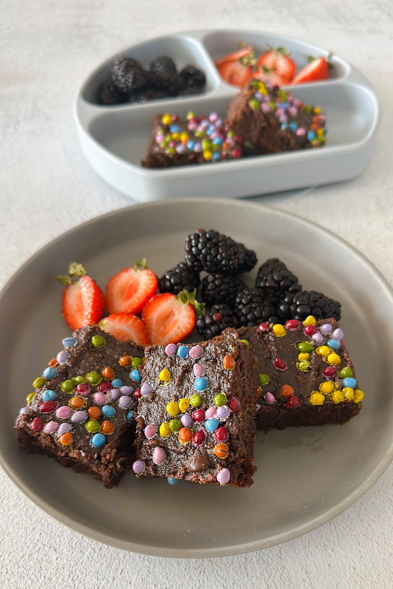 Sweet potato brownies served with berries.