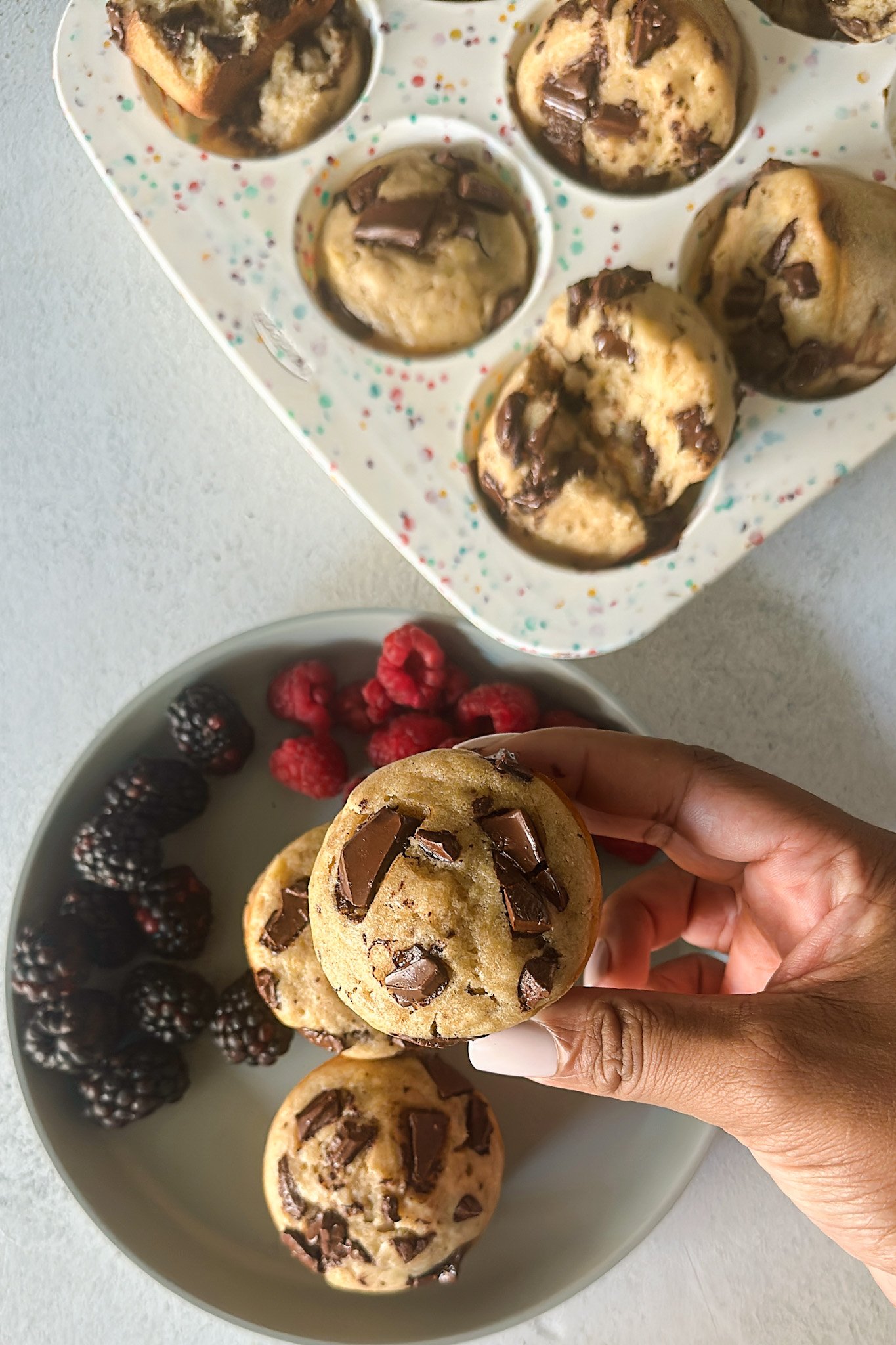 Chocolate chunk banana muffins served with berries.