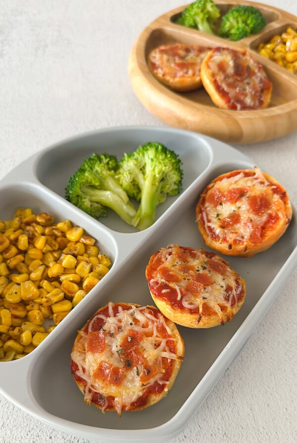 Homemade bagel bites served with corn and broccoli.