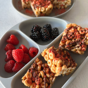 Cheerio cereal bars served with berries.