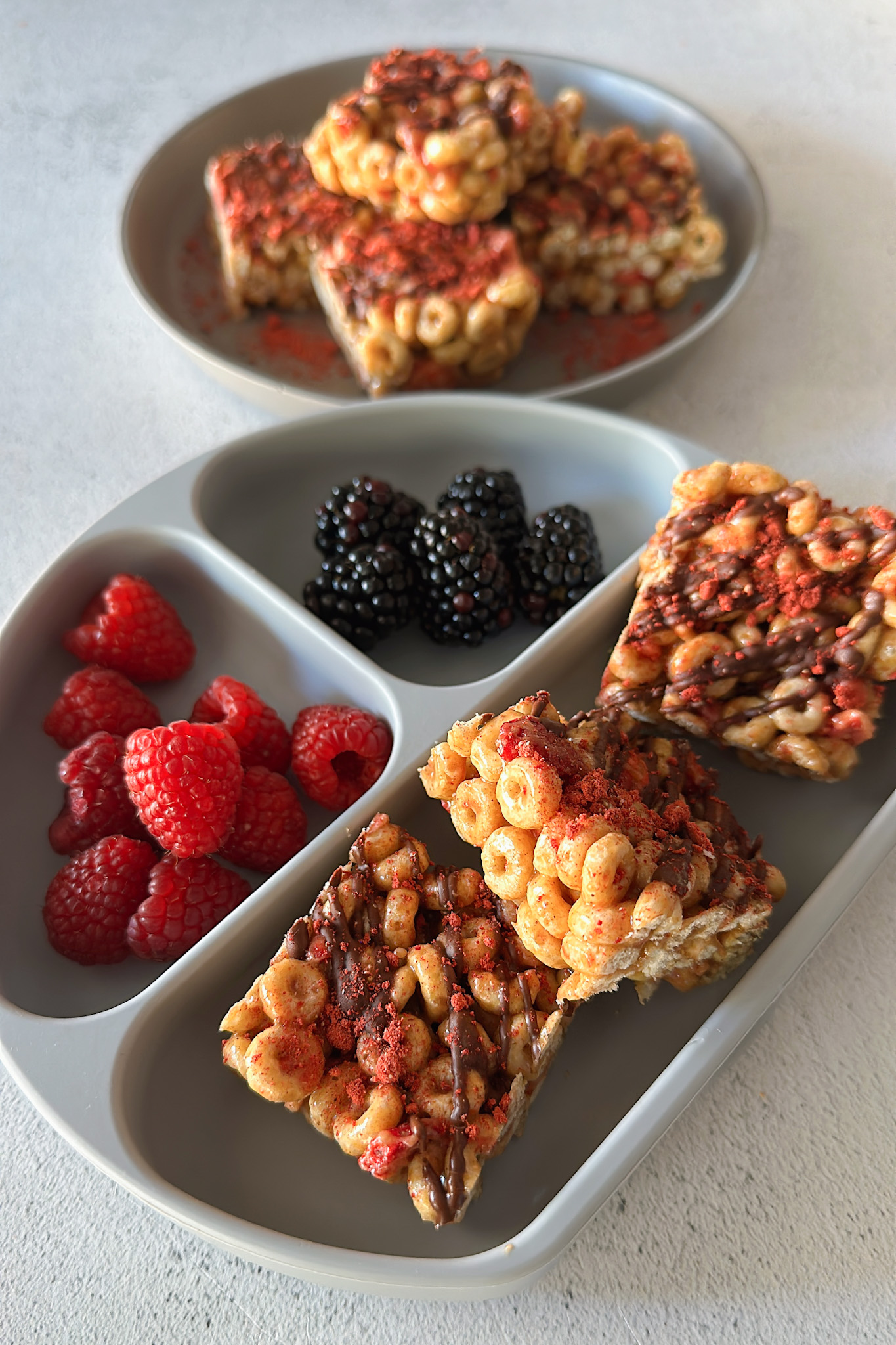 Cheerio cereal bars served with berries.