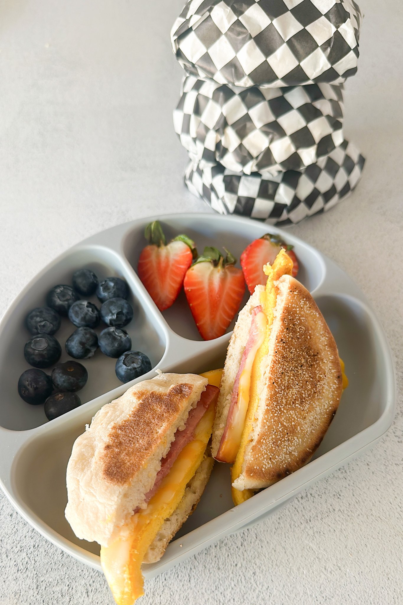 Freezer breakfast sandwich served with berries.