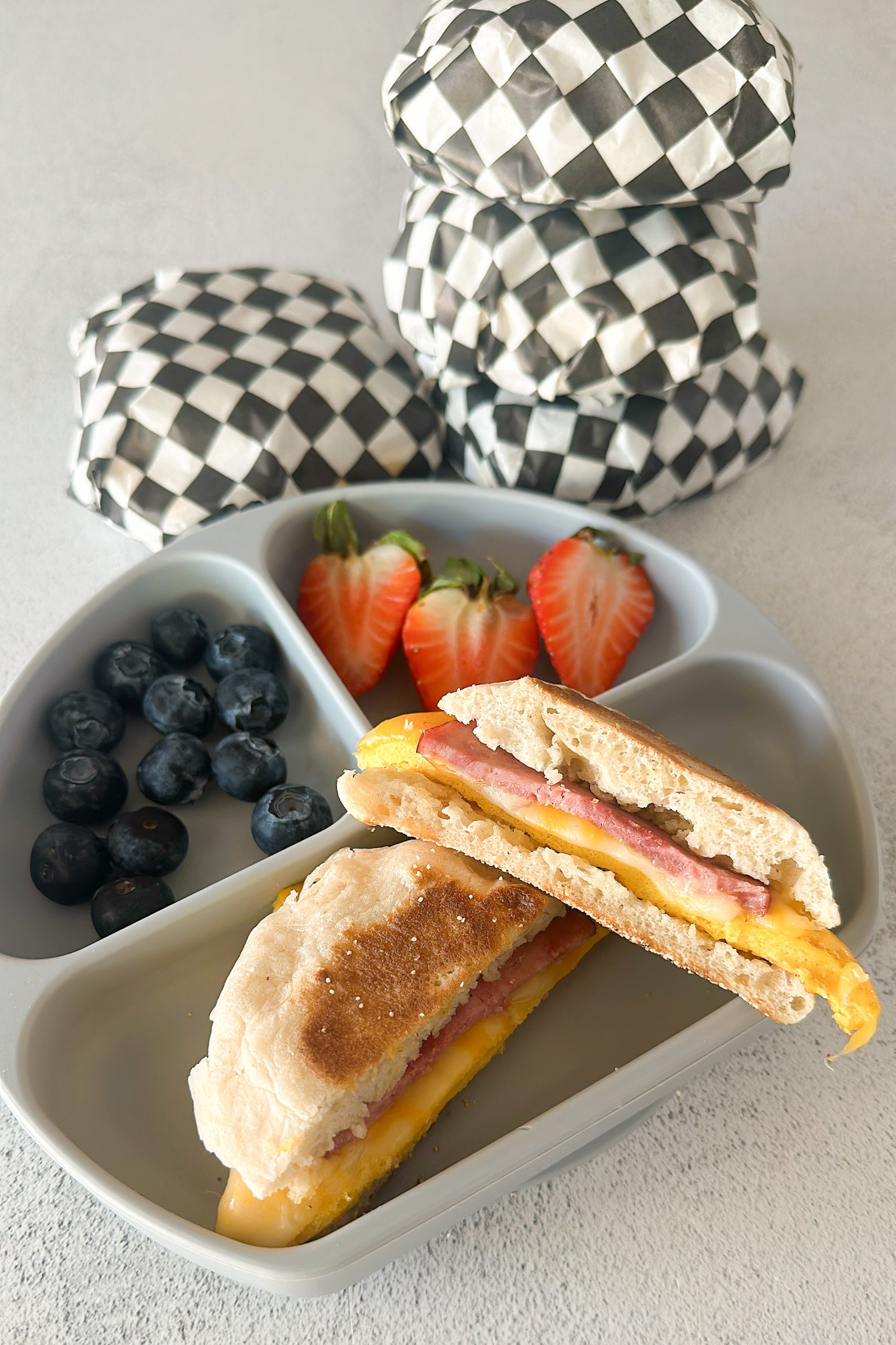 Freezer breakfast sandwich served with berries.