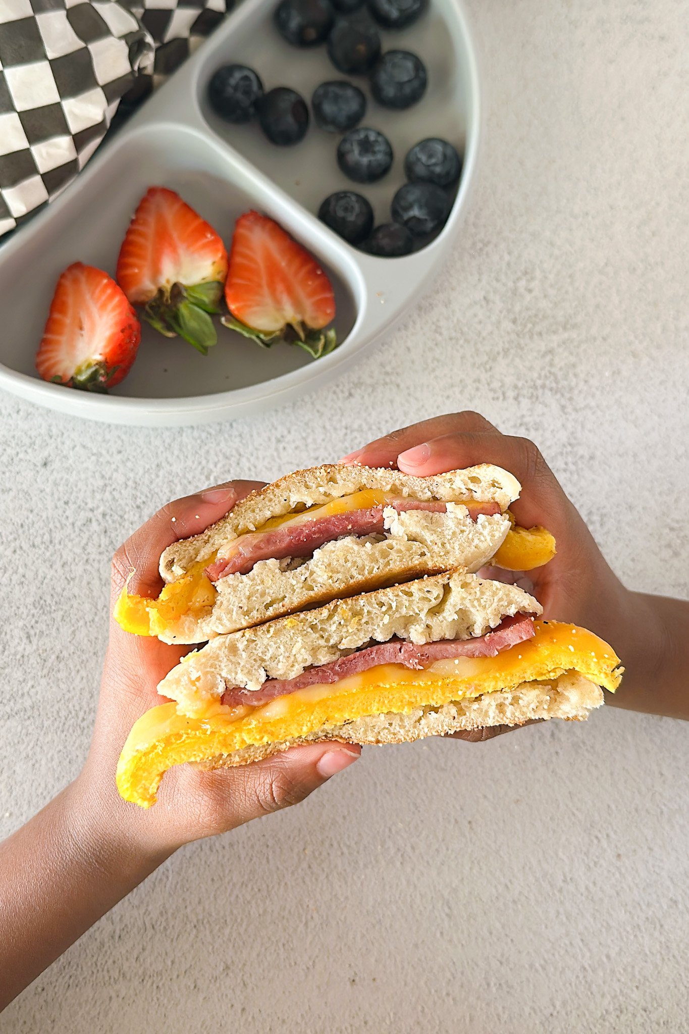 Freezer breakfast sandwich served with berries.