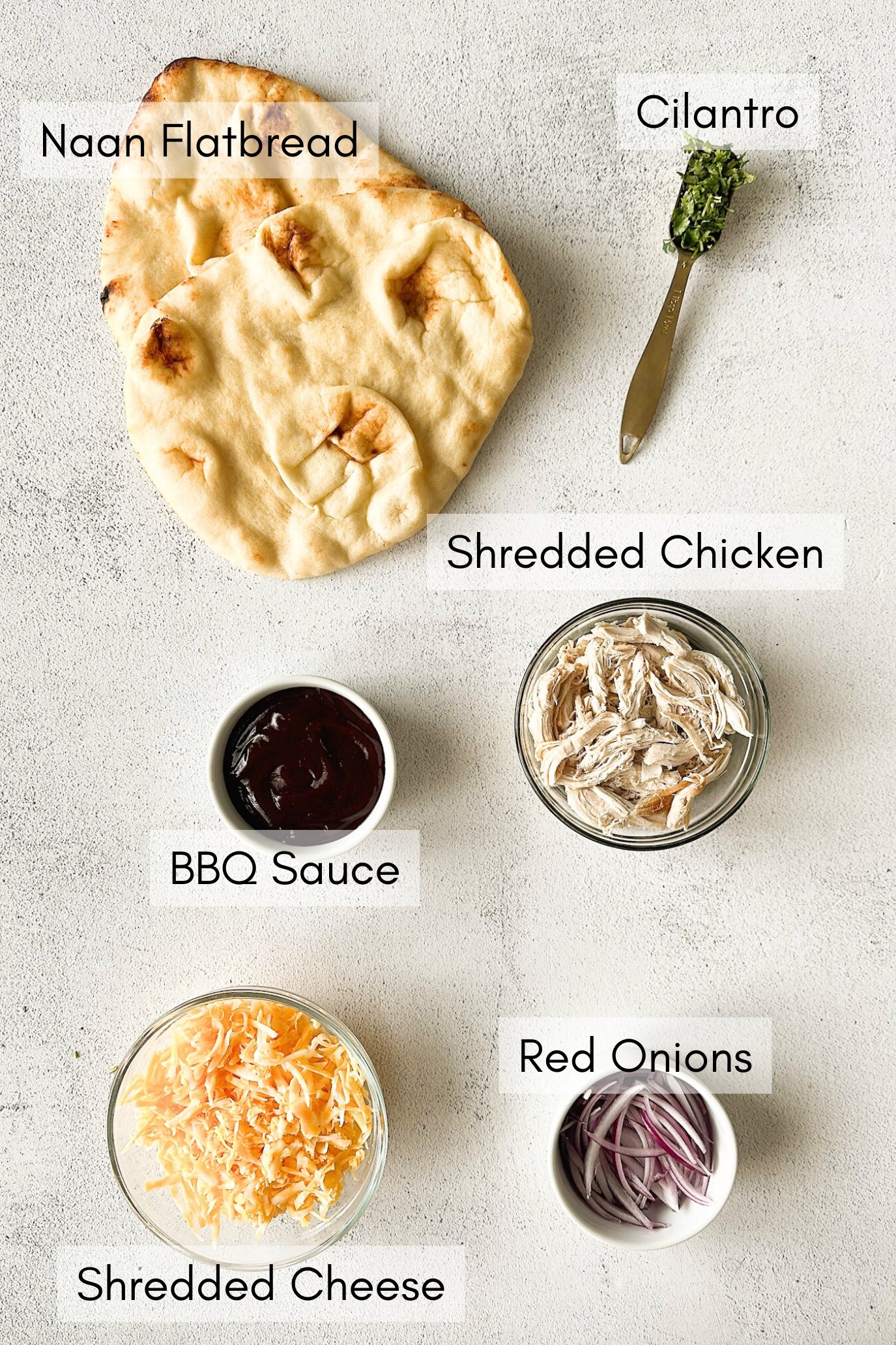 Ingredients to make BBQ chicken naan pizzas.