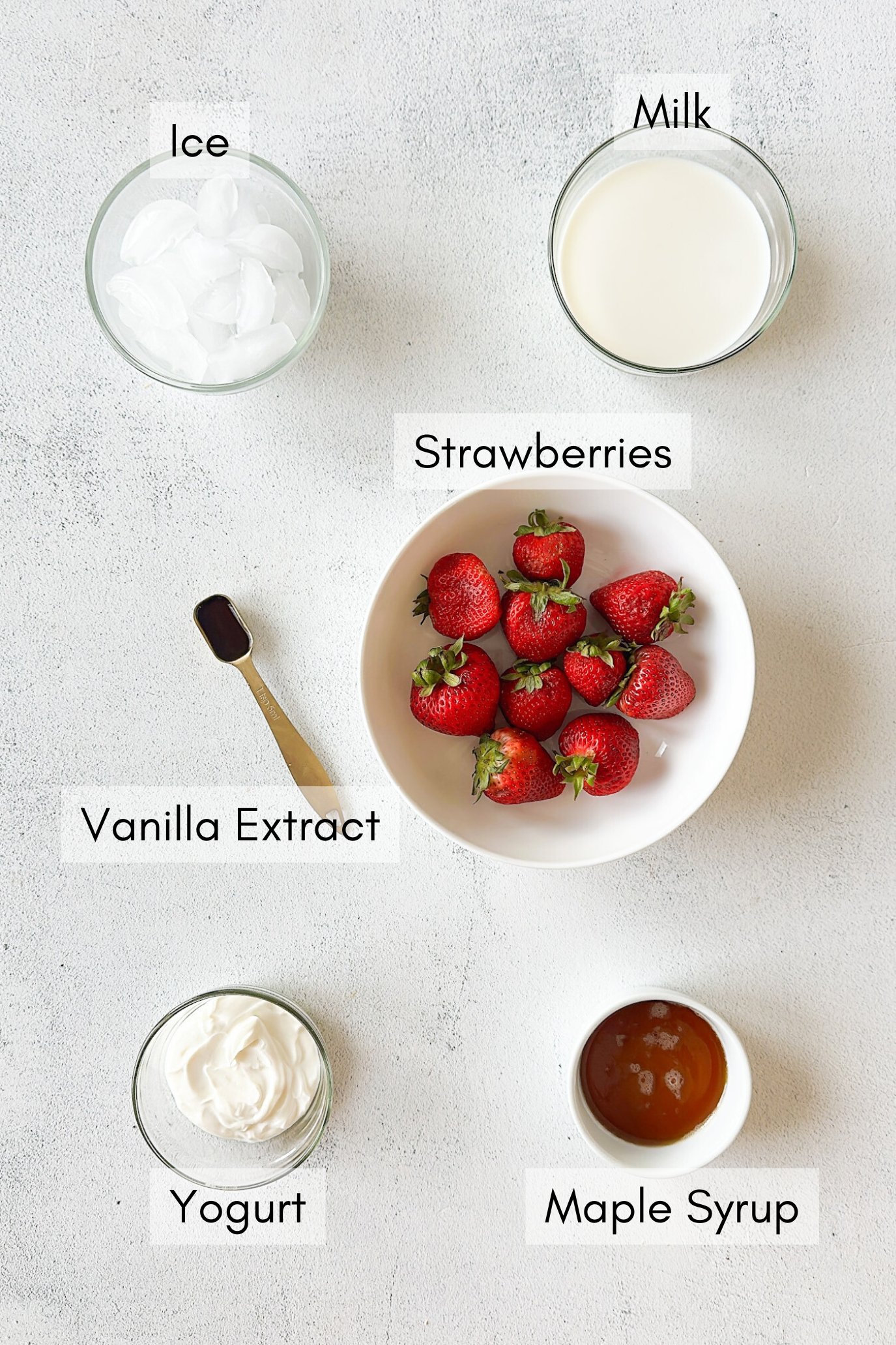 Ingredients to make strawberry yogurt smoothie.