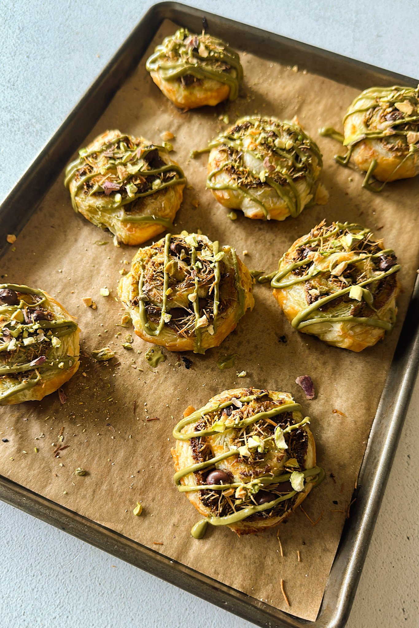 Pistachio rolls on a baking sheet.