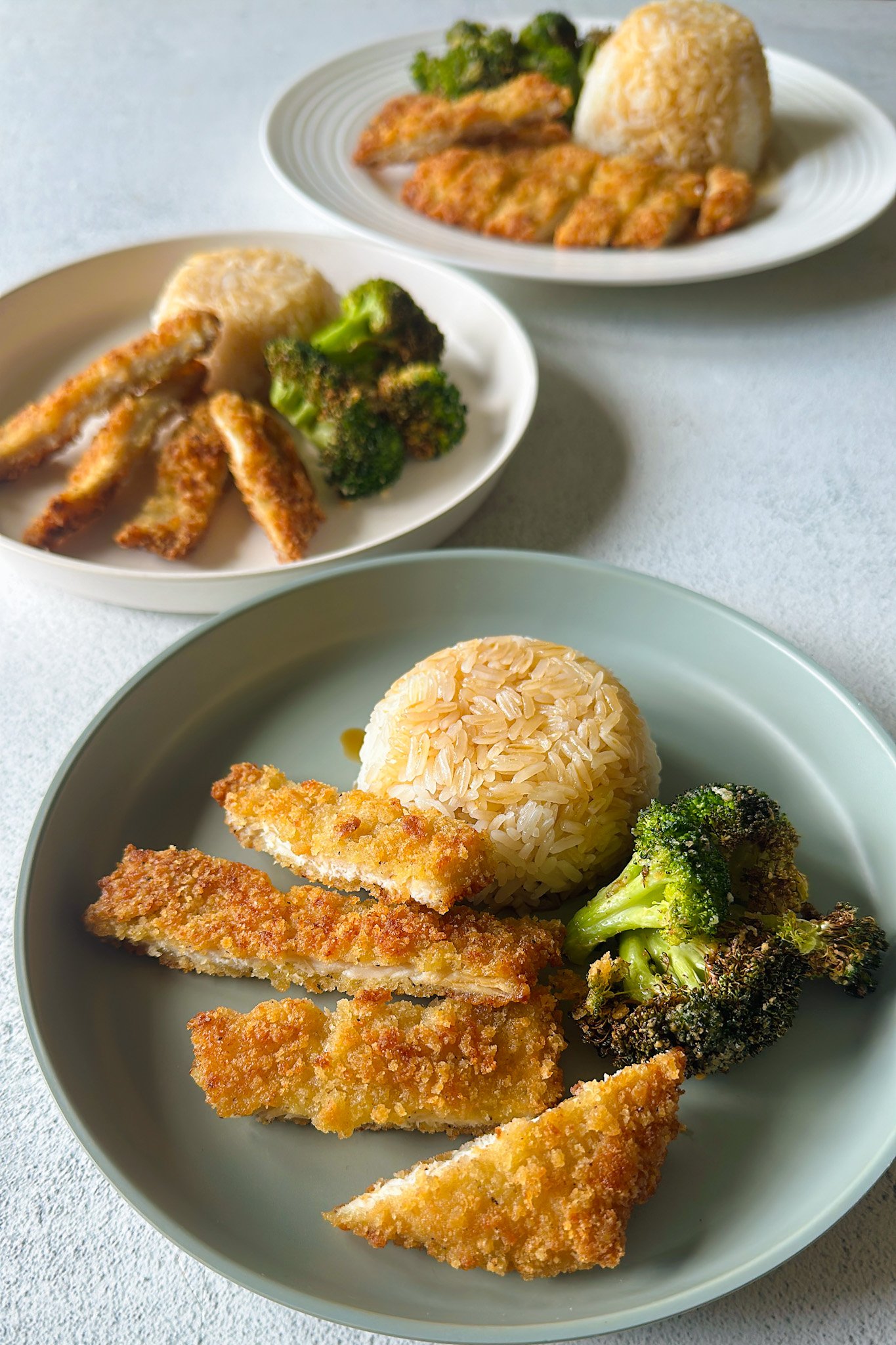 Crispy panko chicken served with broccoli and rice.