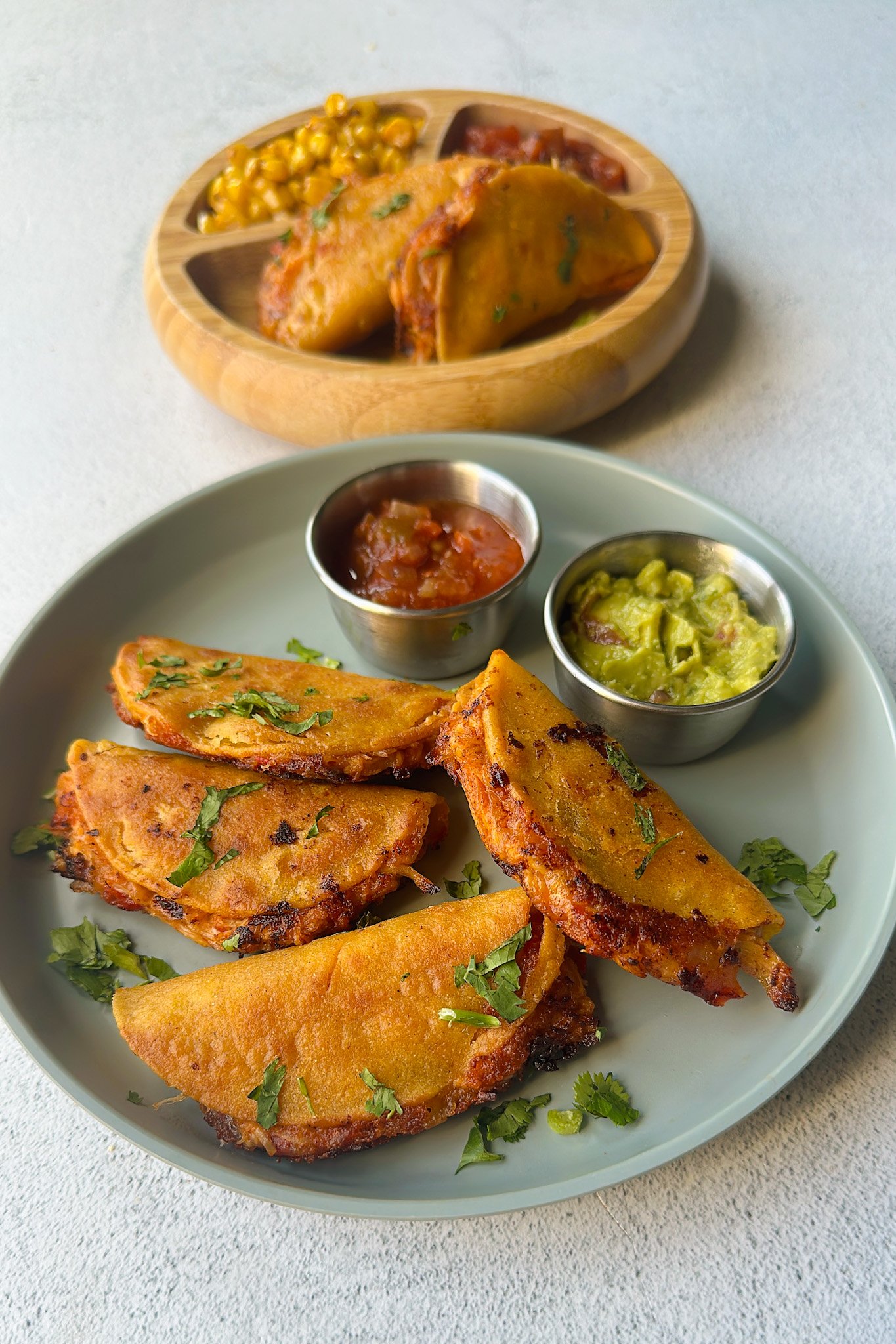 Mini chicken tacos served with dips.