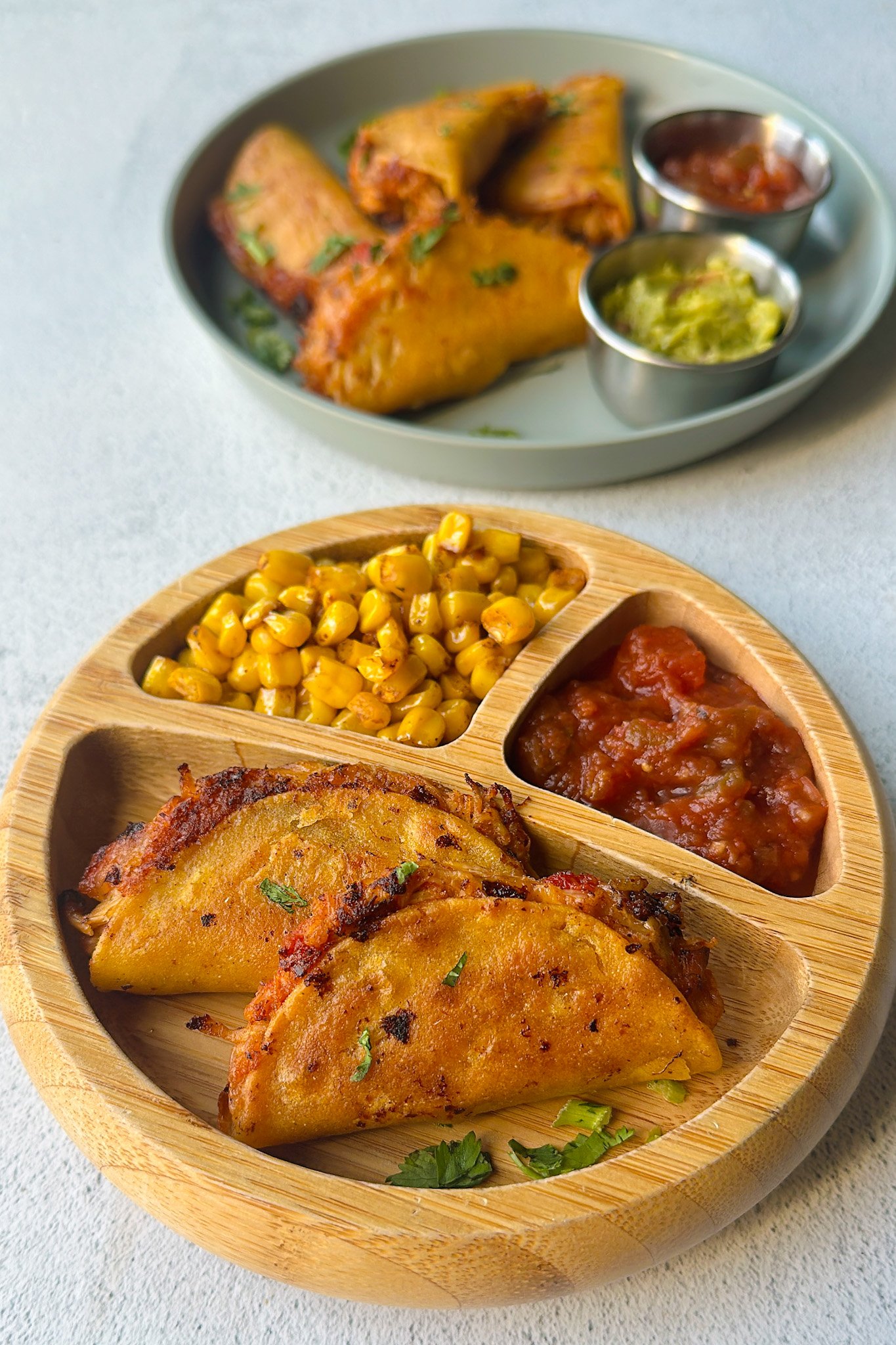 Mini chicken tacos served with dips.