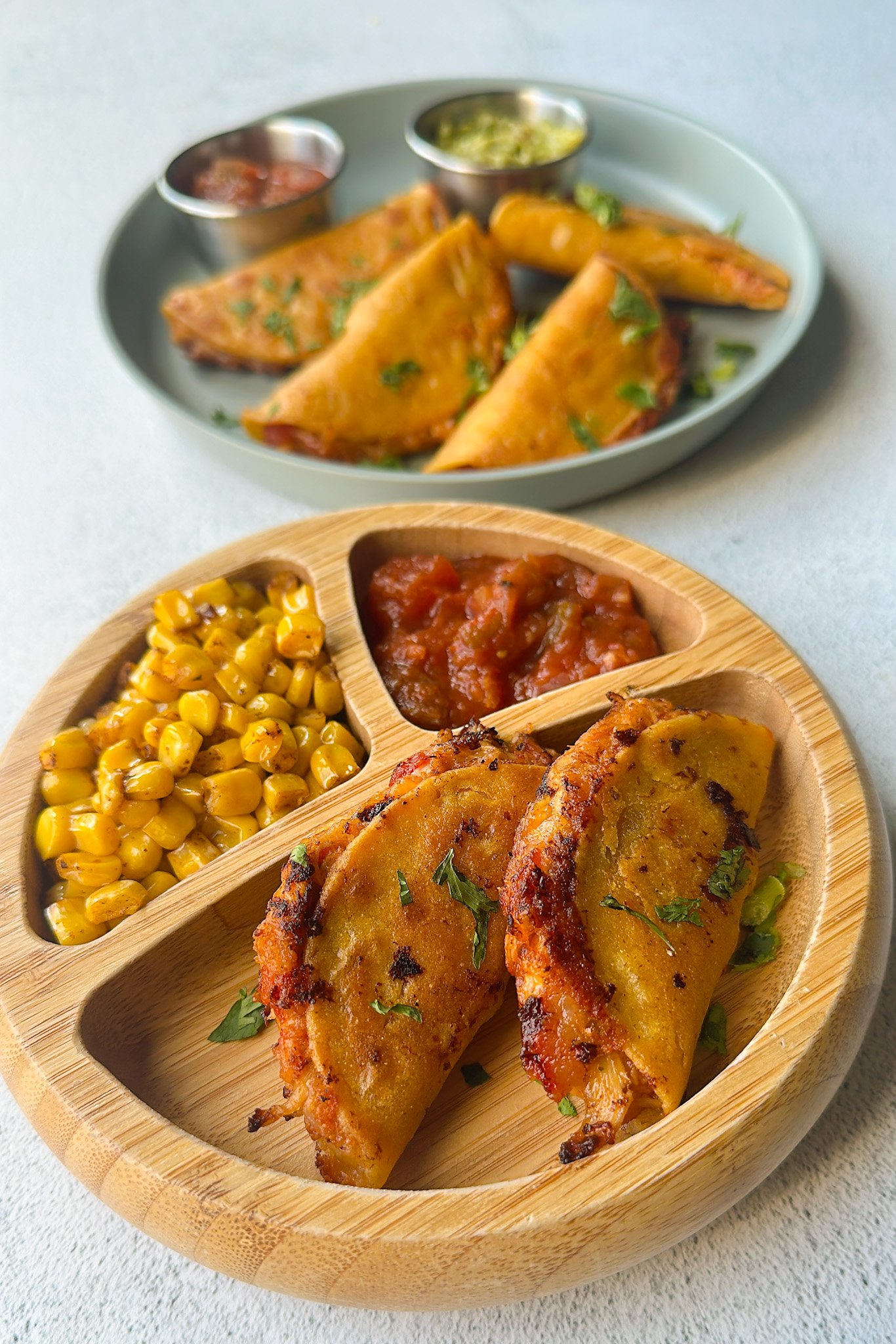 Mini chicken tacos served with dips.