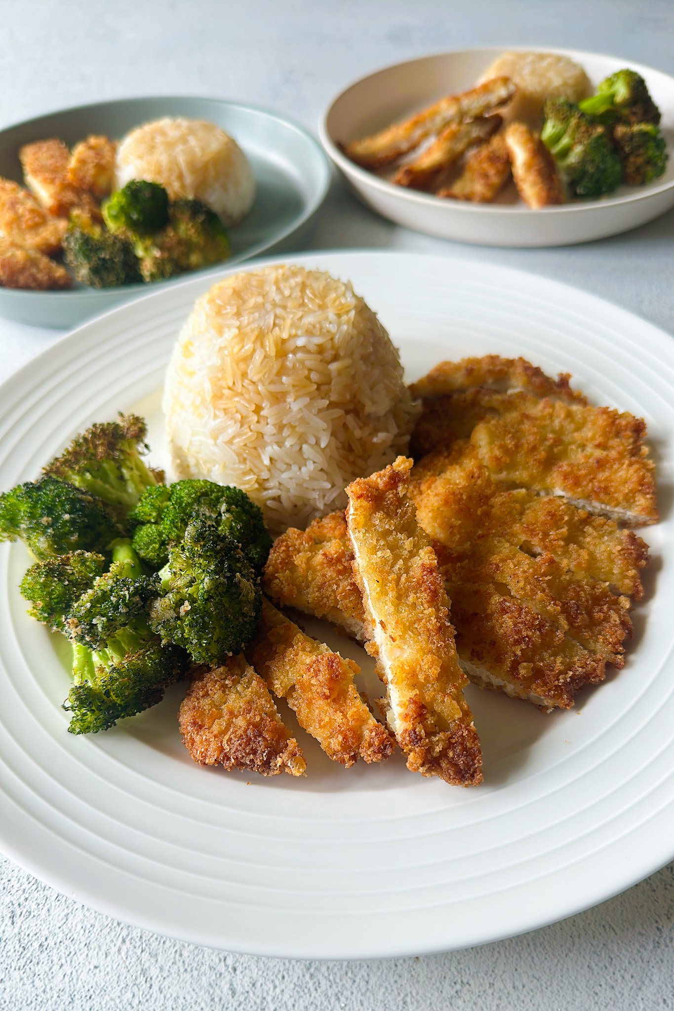 Crispy panko chicken served with broccoli and rice.