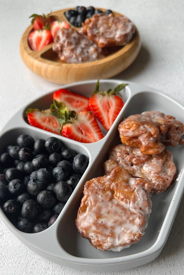 Applesauce fritters served with berries.