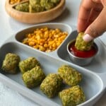 Broccoli tots served with ketchup, corn, and berries.