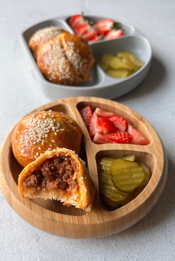 Cheeseburger bombs served with pickles and strawberries.