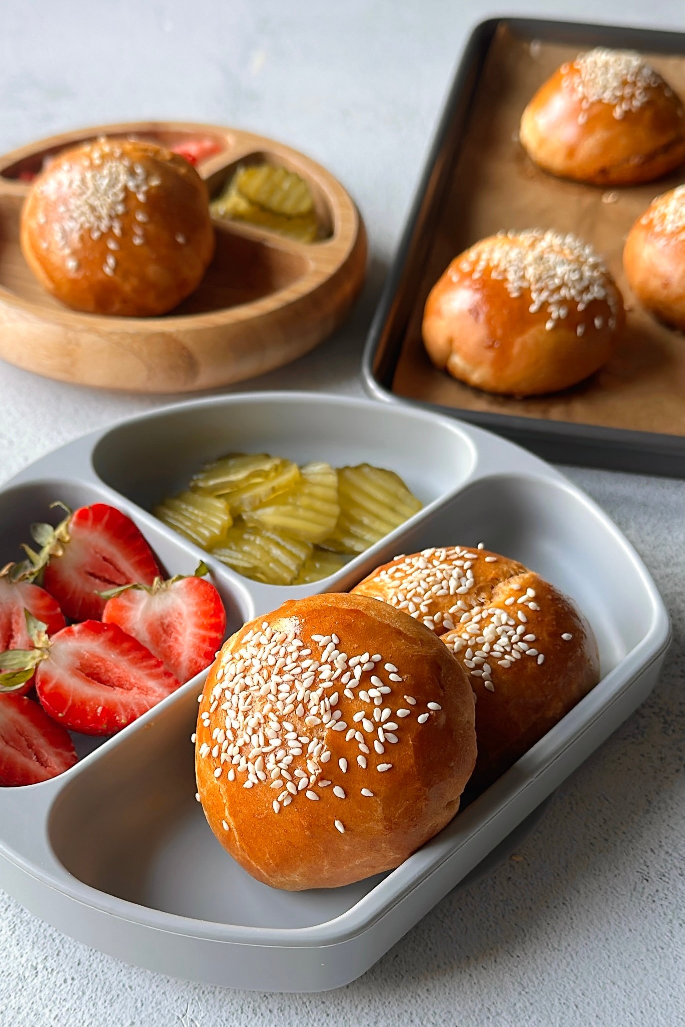 Cheeseburger bombs served with pickles and strawberries.