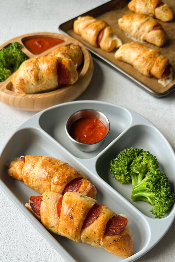 Crescent pizza rolls served with broccoli and marinara sauce.