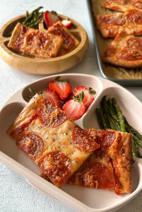 Cottage cheese pizza served with strawberries and asparagus.