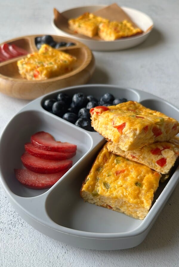 Cottage cheese egg casserole served with plum slices and blueberries.