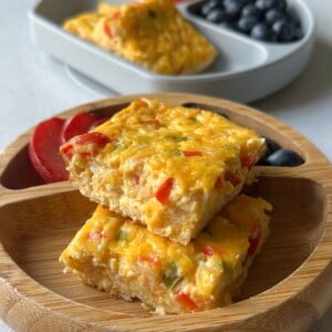 Cottage cheese egg casserole served with plum slices and blueberries.