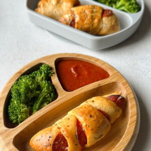 Crescent pizza rolls served with broccoli and marinara sauce.