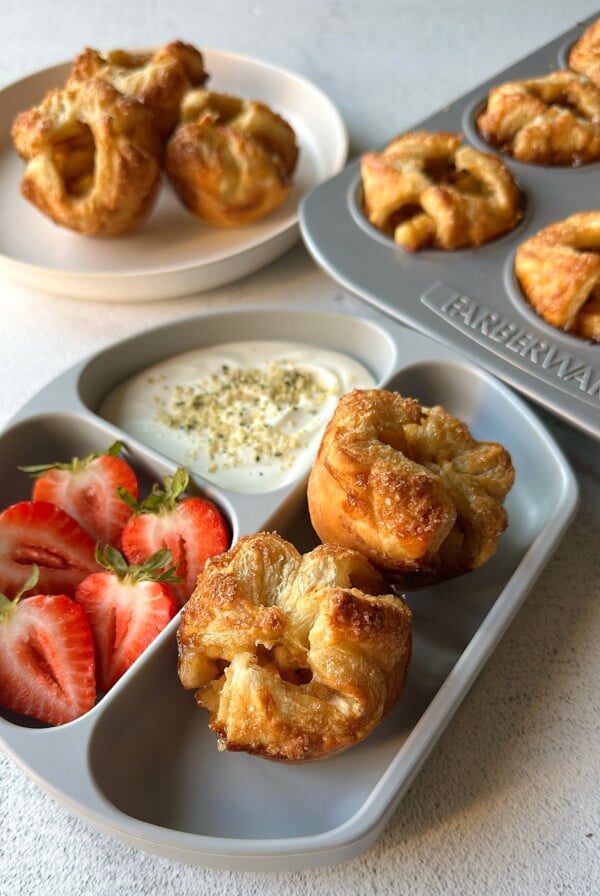 Baked apple croissant served with strawberries and yogurt.