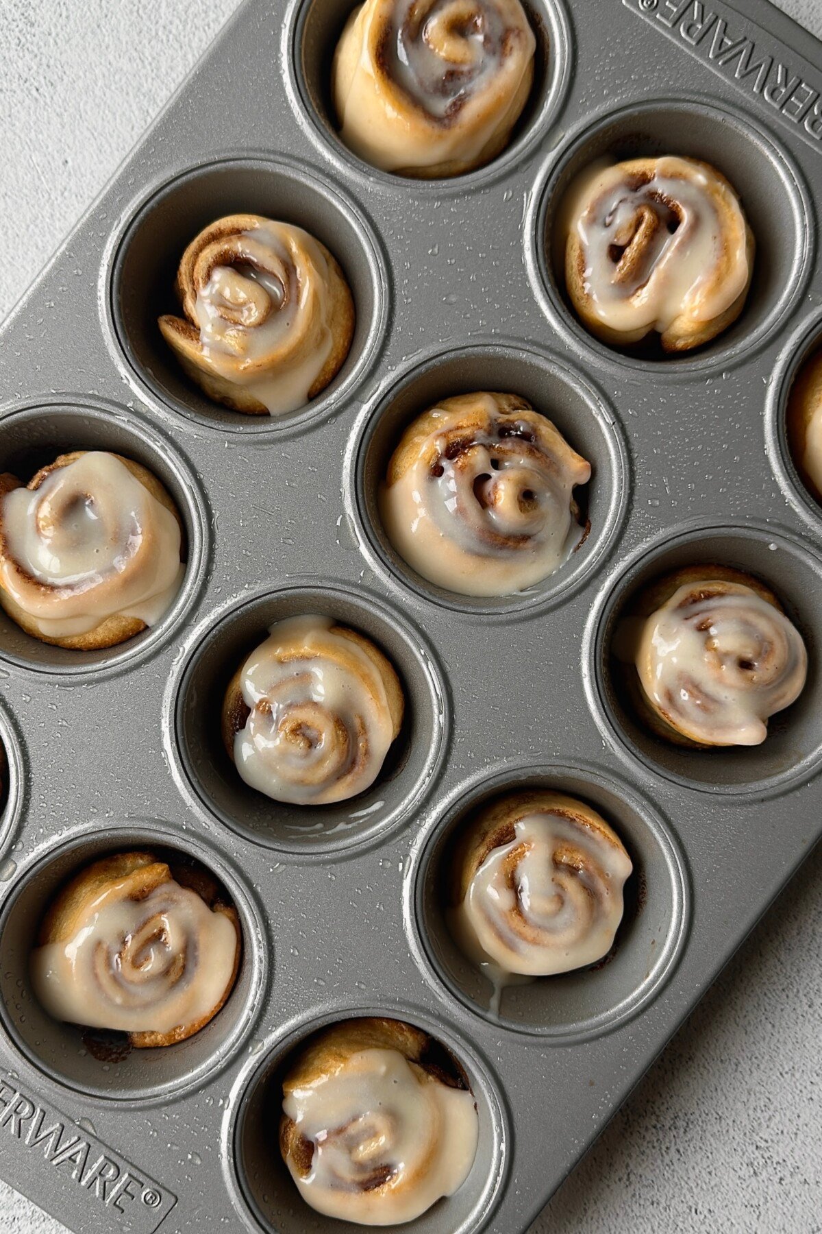 Cinnamon roll crescent rolls in muffin pan.