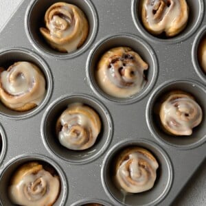 Cinnamon roll crescent rolls in muffin pan.
