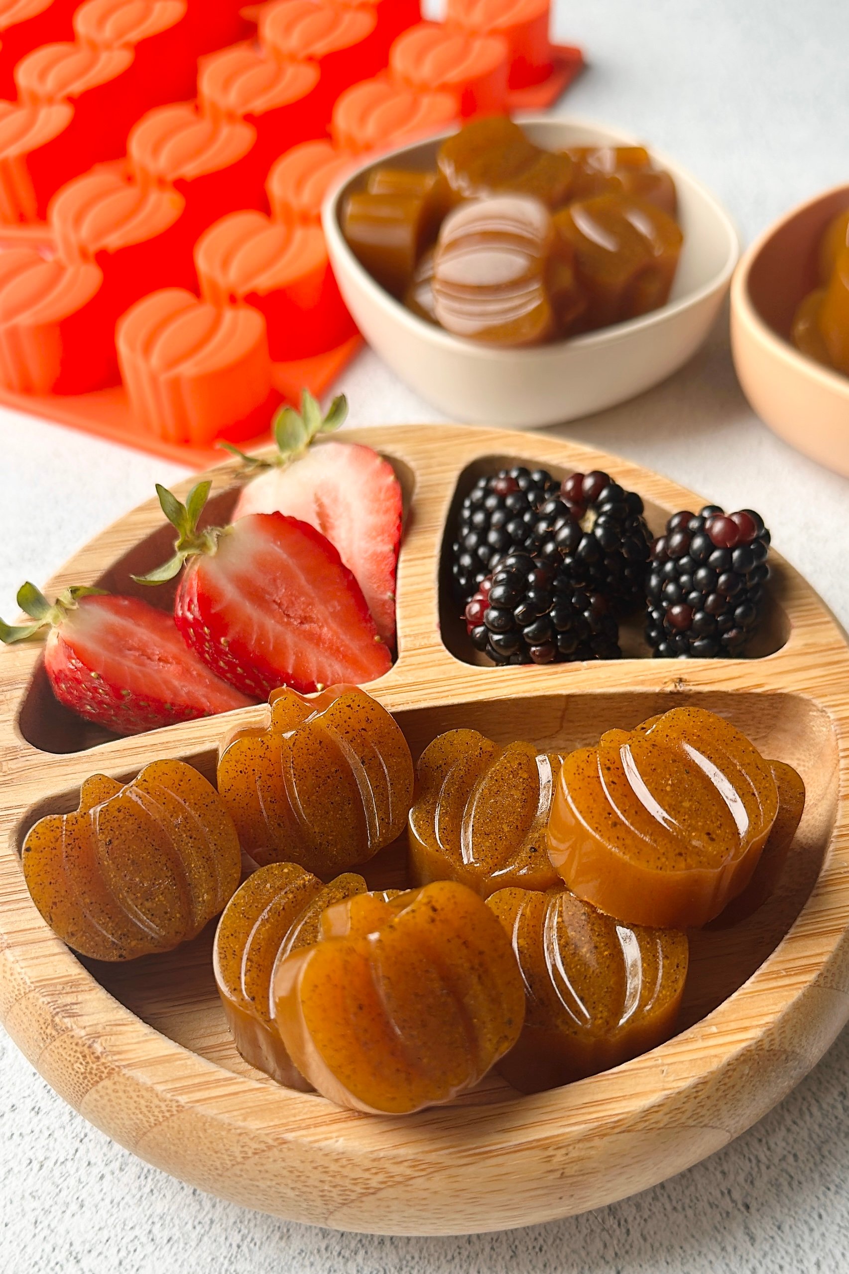 Pumpkin gummies served with berries.